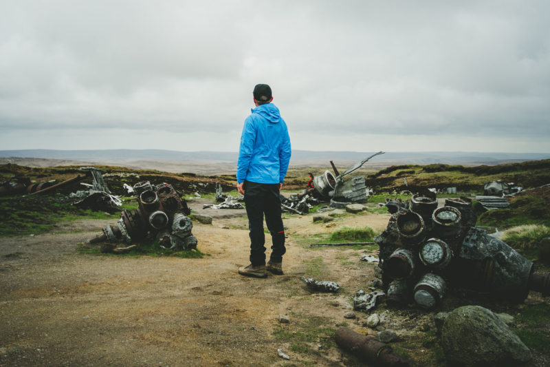 Writer Andrew McCloy surveys airplane wreckage as part of Content Marketing piece for outdoor brand, Mammut
