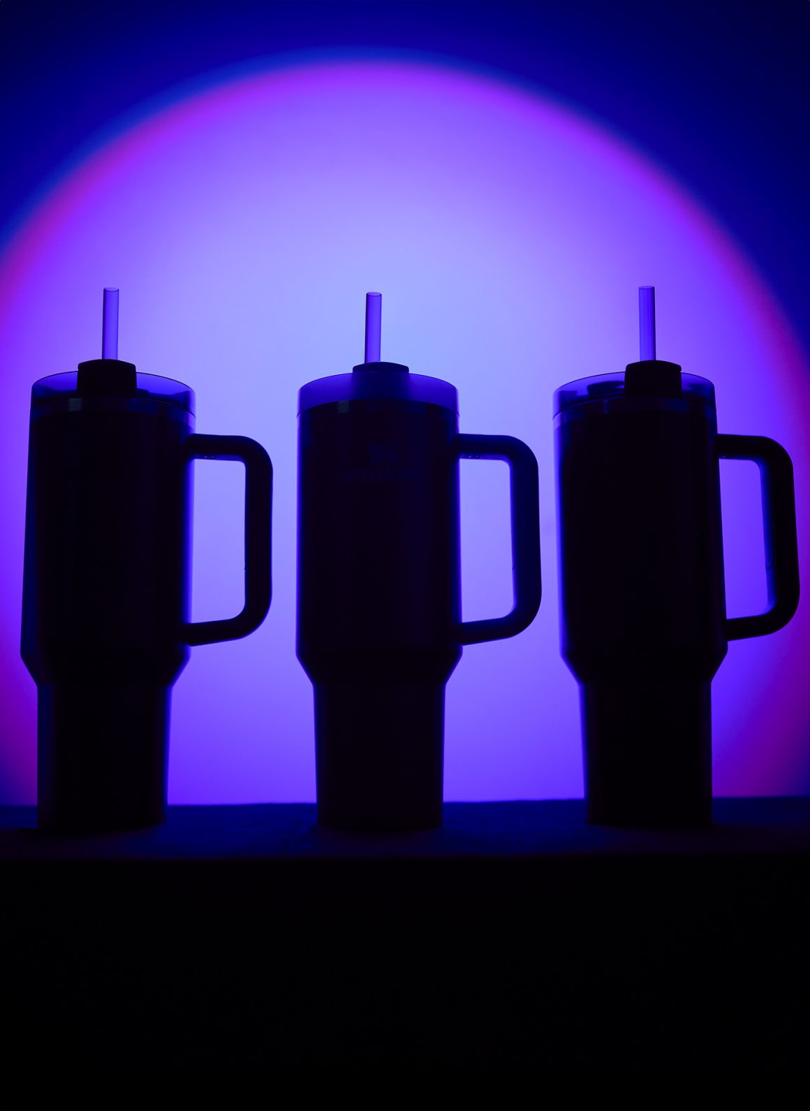 Shadow of three lined up Stanley Quenchers