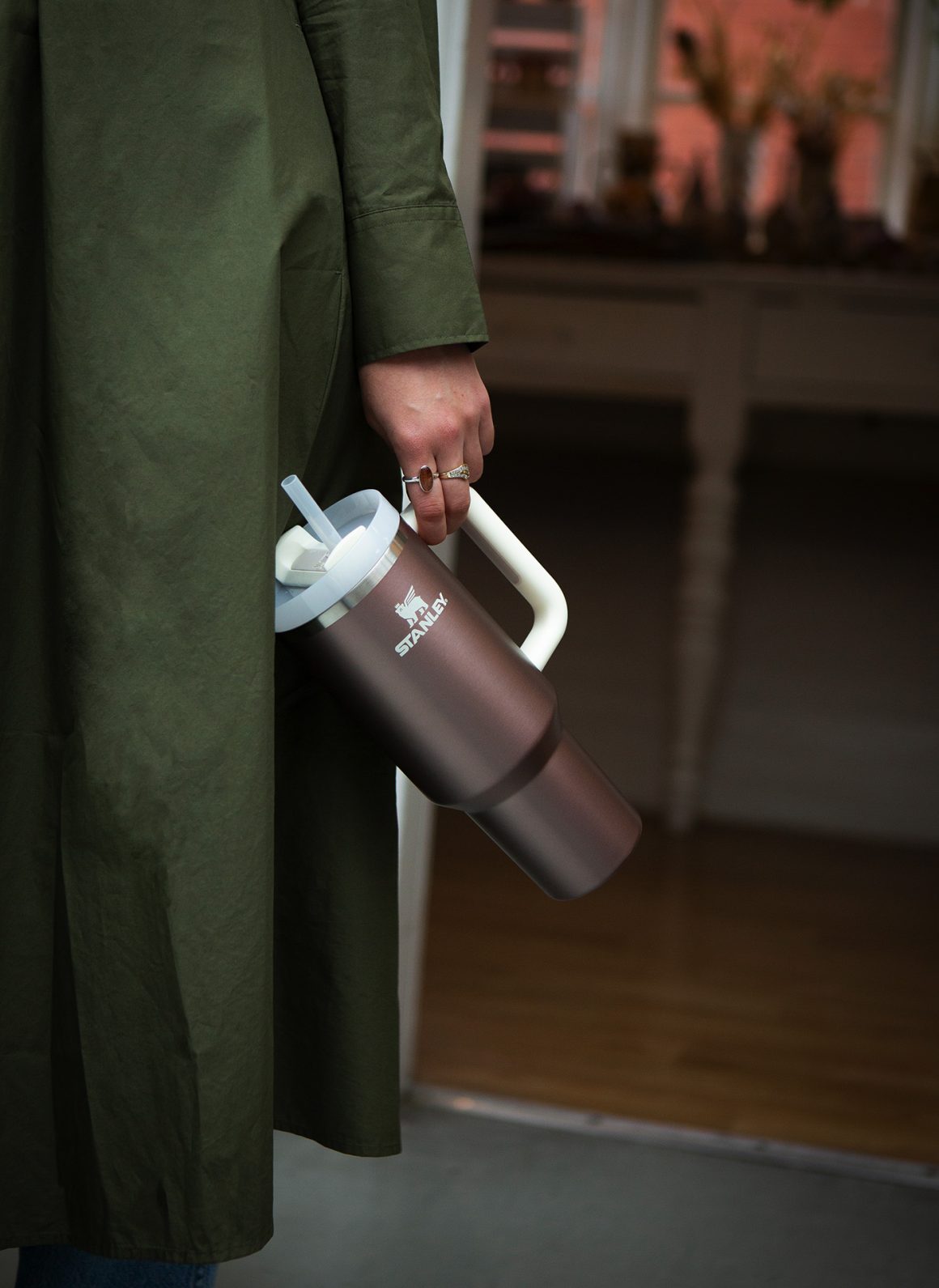 Stanley Quencher being held by woman's side