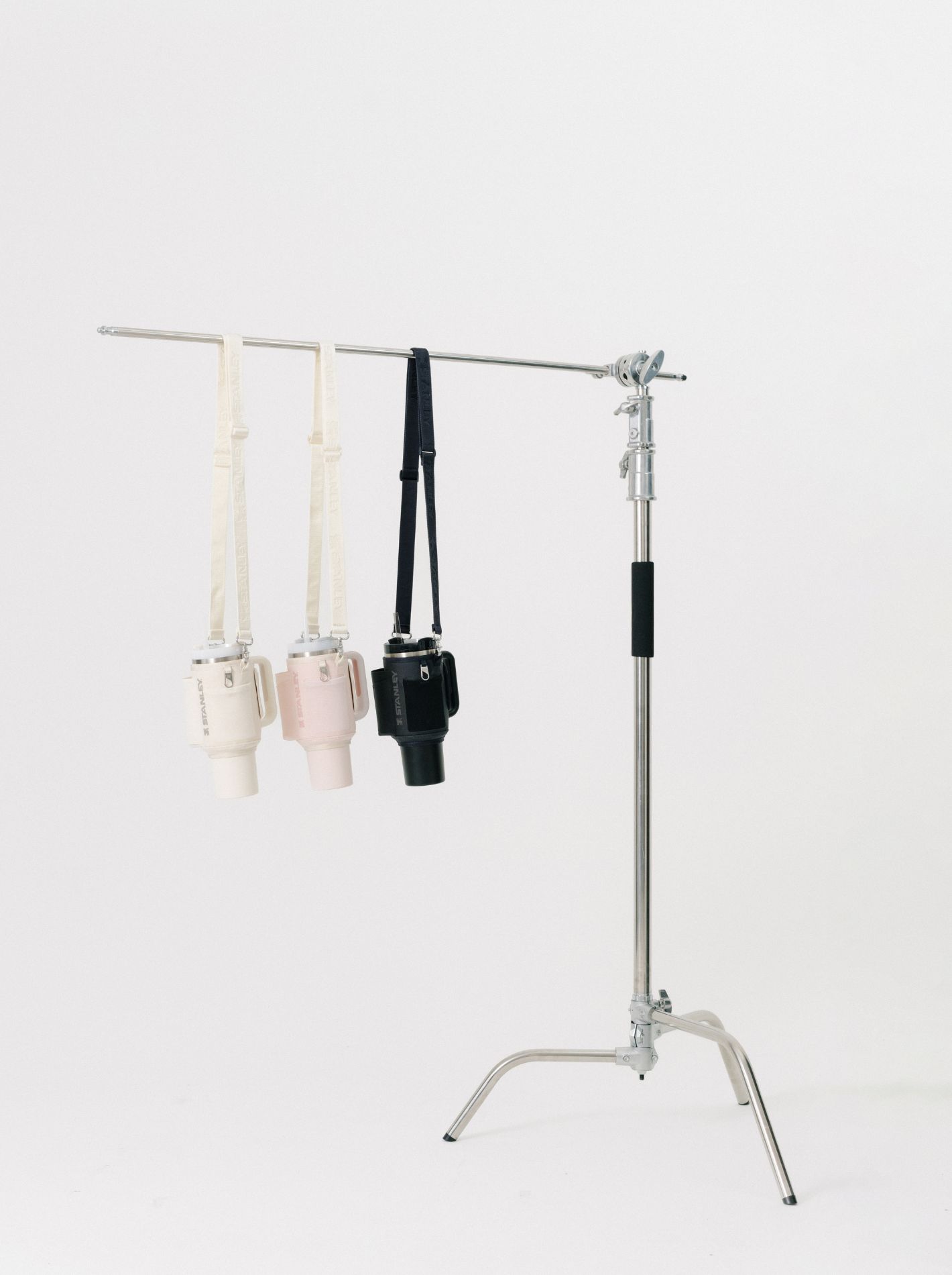 Three Stanley Quenchers hanging from a C stand