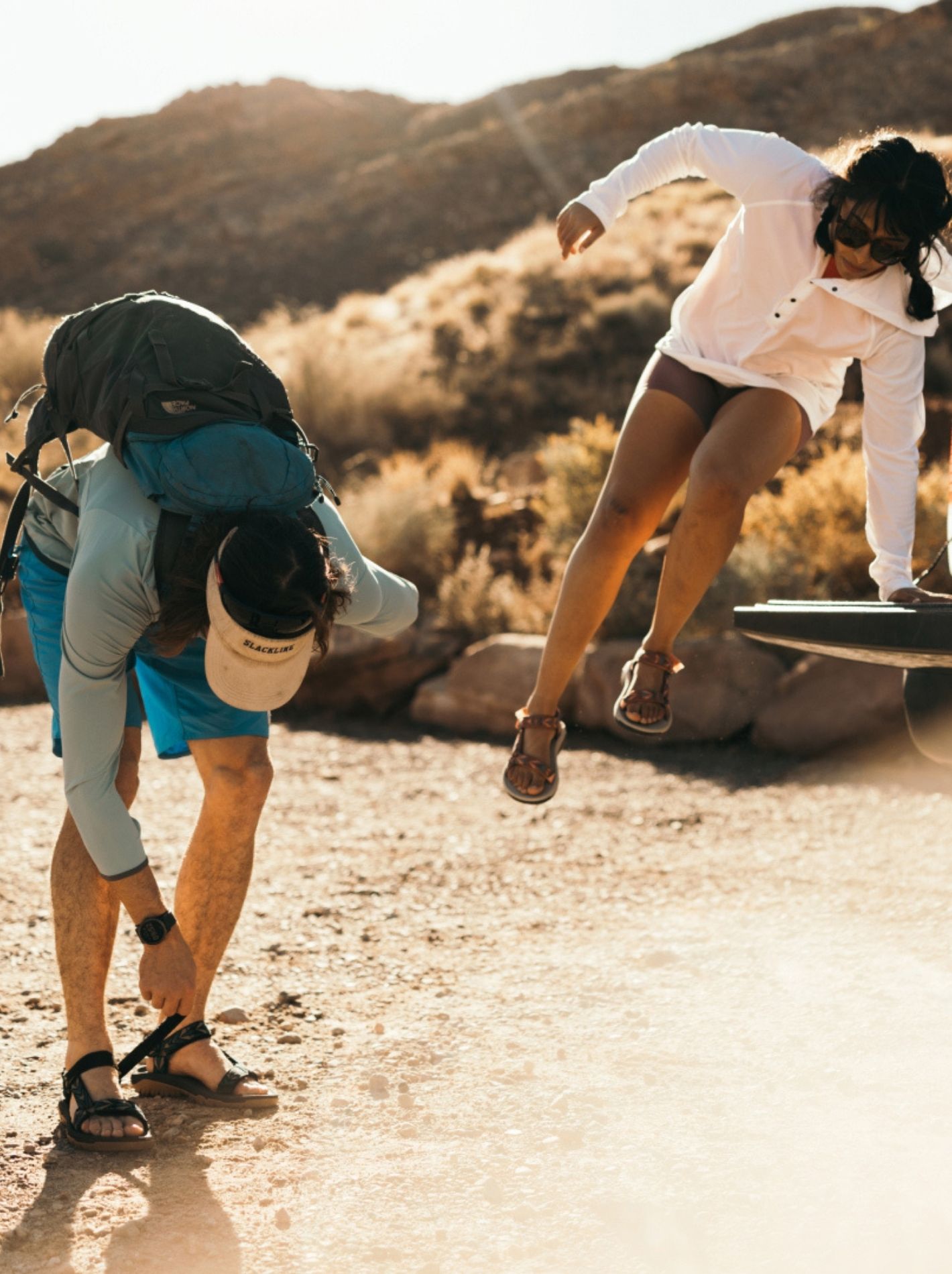 Two models featured outdoors wearing Teva sandals