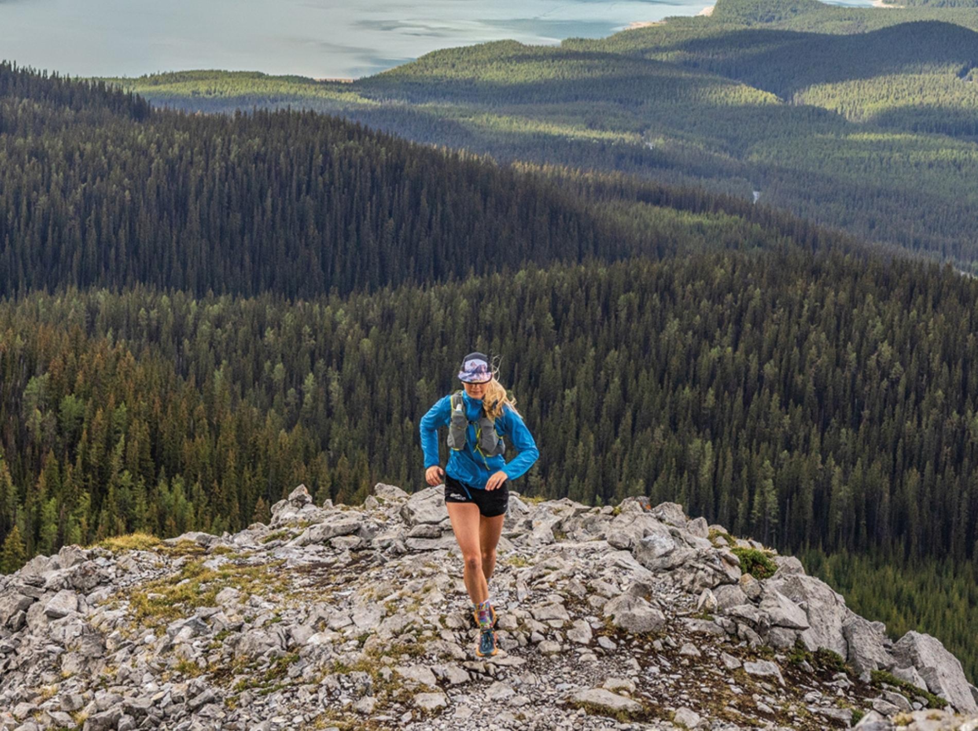Image of a woman running on a rocky precipice