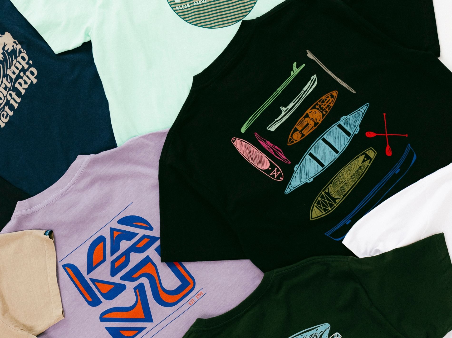 Flat lay of multiple KAVU t shirts