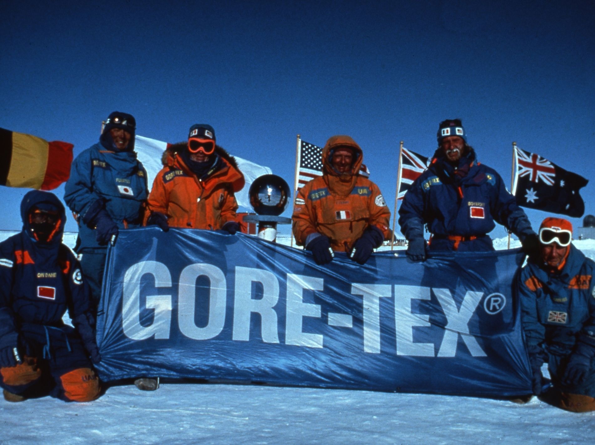 People stand behind Gore Tex banner on expedition.
